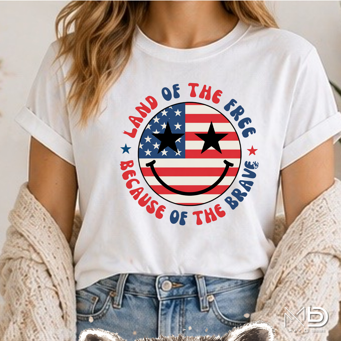 Land of the Free Because of the Braves Patriotic Smiley Face Shirt | American Flag Happy Face Tee | Fourth of July Graphic T-Shirt | USA Independence Day Shirt