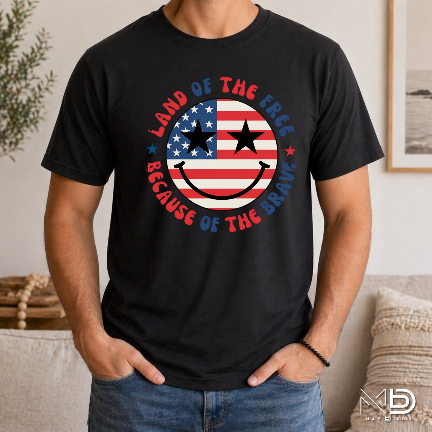 Land of the Free Because of the Braves Patriotic Smiley Face Shirt | American Flag Happy Face Tee | Fourth of July Graphic T-Shirt | USA Independence Day Shirt